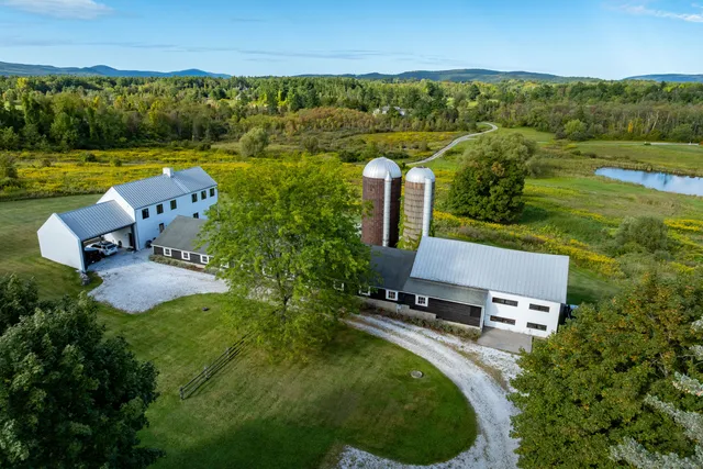 an aerial view of a house with garden space and outdoor seating