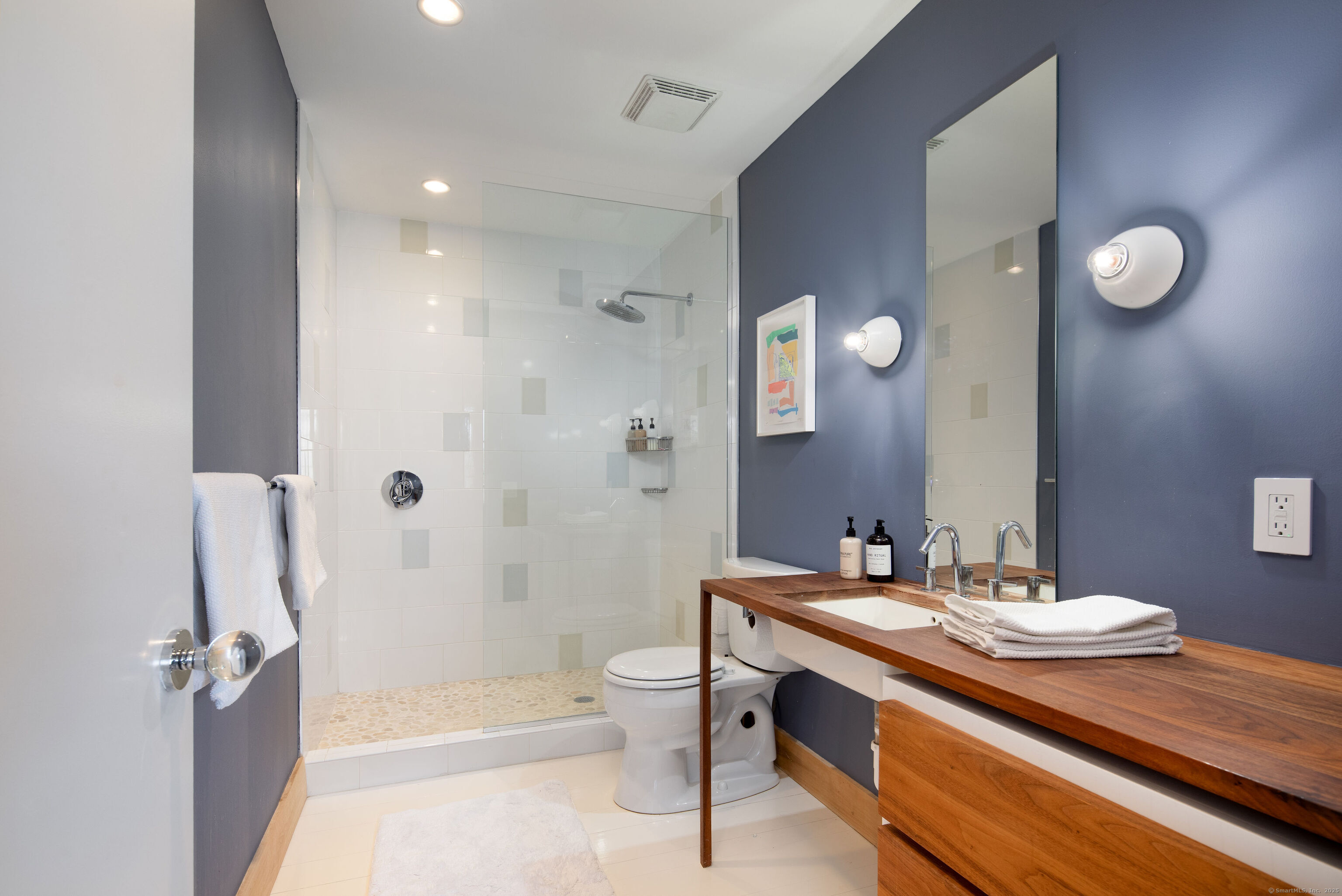 120 Lime Rock Road Salisbury, CT 06039 - Photo 24 of 35 a spacious bathroom with a granite countertop sink a toilet a mirror and shower