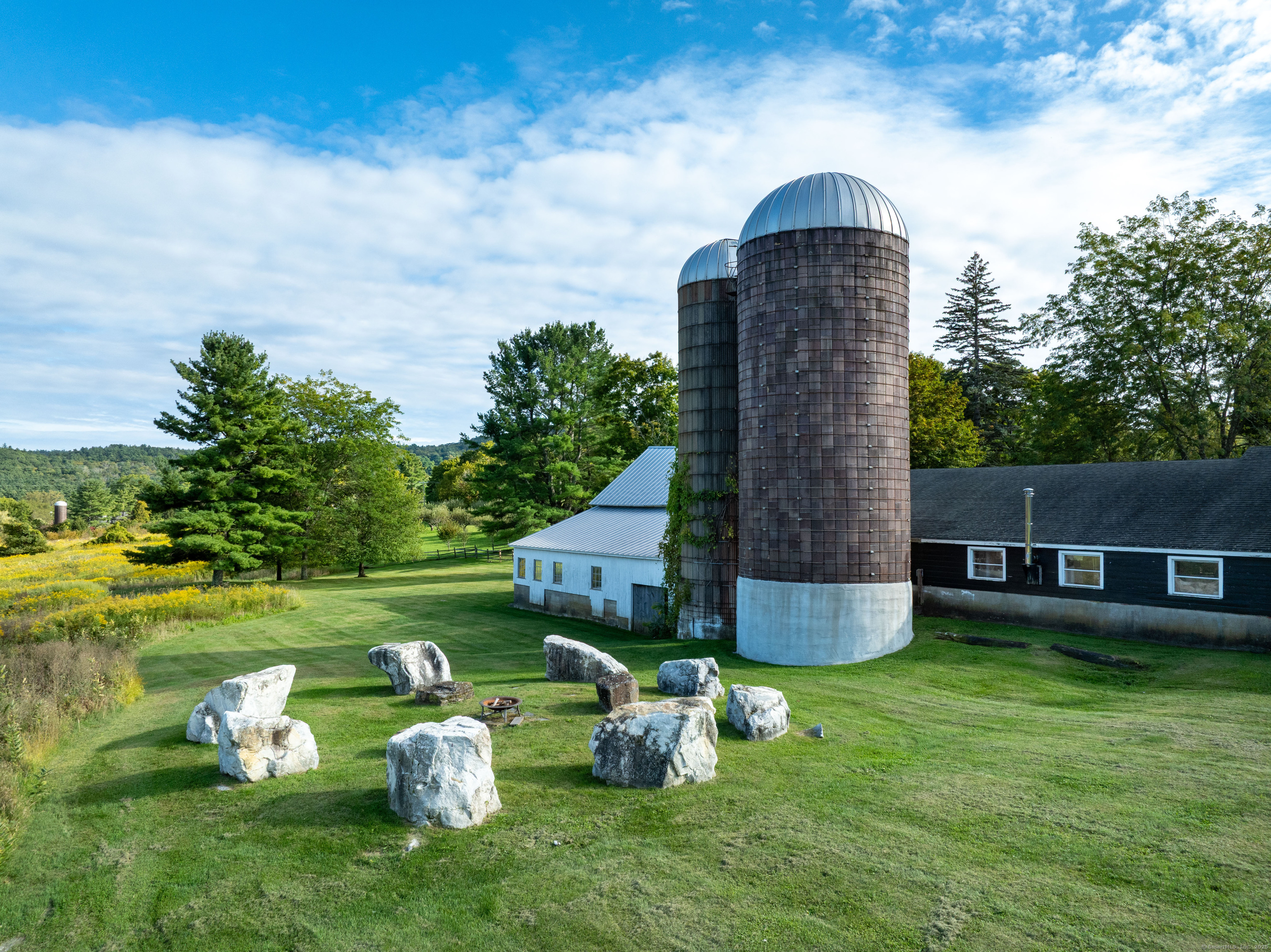 120 Lime Rock Road Salisbury, CT 06039 - Photo 26 of 35 a backyard of a house with table and chairs plants and large tree