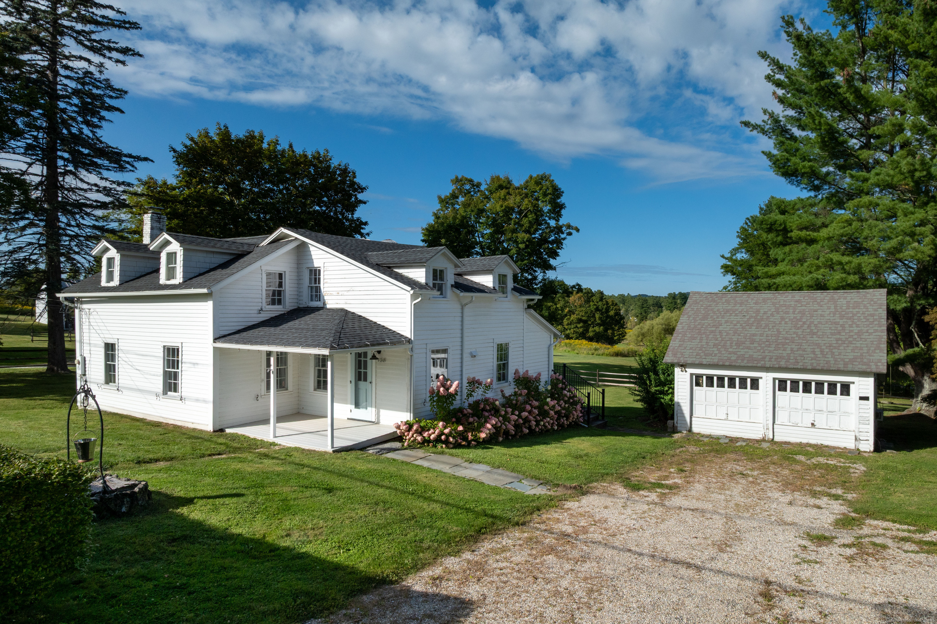 120 Lime Rock Road Salisbury, CT 06039 - Photo 28 of 35 a view of a house with a yard potted plants and a large tree