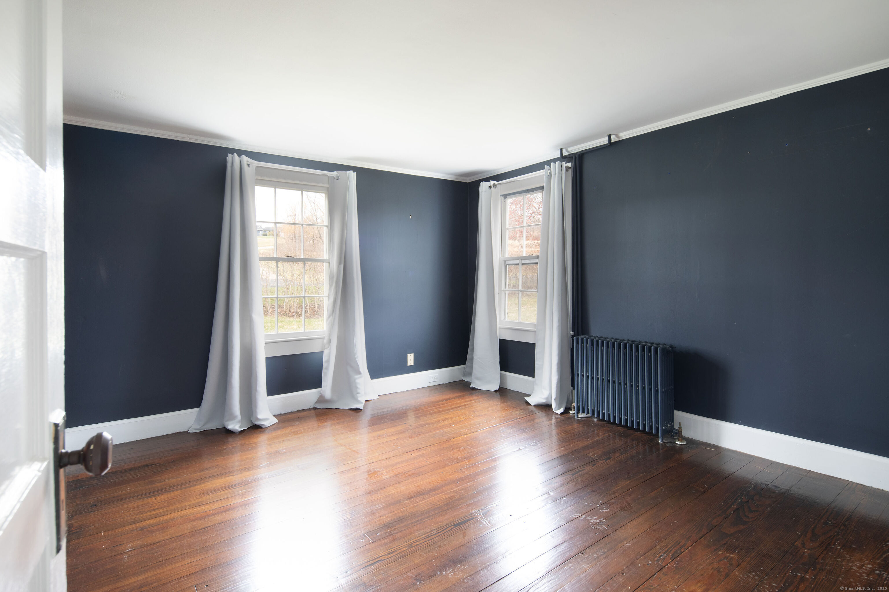 120 Lime Rock Road Salisbury, CT 06039 - Photo 34 of 35 an empty room with wooden floor and windows