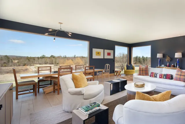 a living room with furniture and a floor to ceiling window