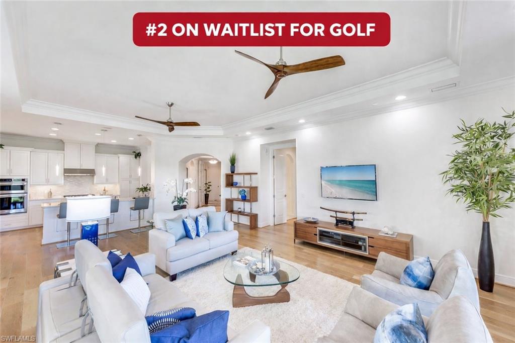 a living room with furniture kitchen view and a potted plant