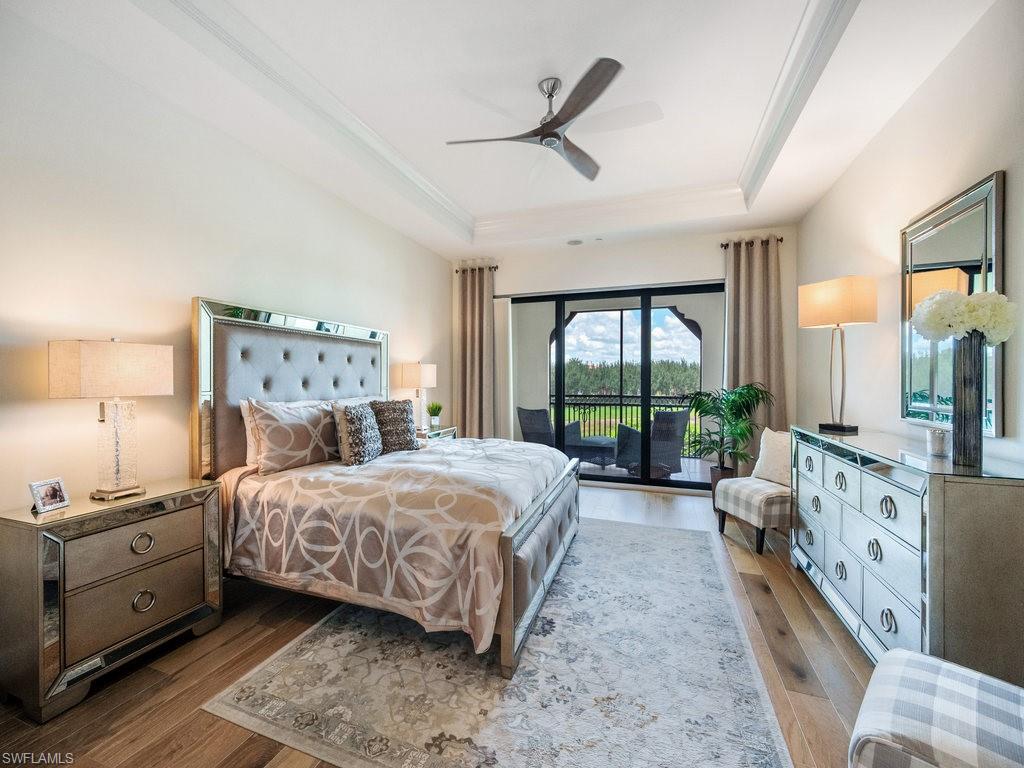 16425 Carrara Way, Unit 101 Naples, FL 34110 - Photo 11 of 21 a bedroom with a large bed and a large window