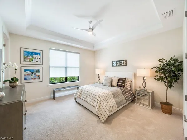 a bedroom with a bed and a painting on the wall