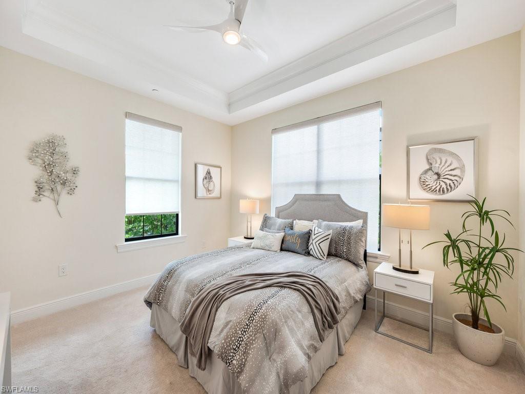 16425 Carrara Way, Unit 101 Naples, FL 34110 - Photo 13 of 21 a bedroom with a bed and a painting on the wall