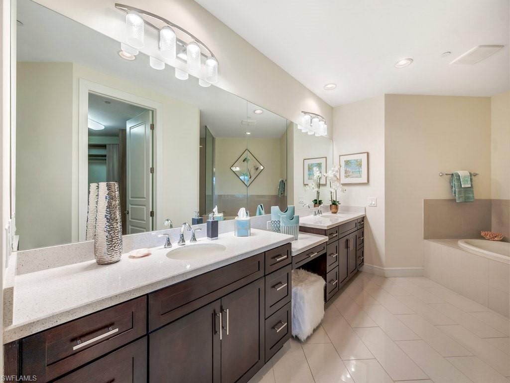16425 Carrara Way, Unit 101 Naples, FL 34110 - Photo 15 of 21 a spacious bathroom with a double vanity sink mirror and bathtub