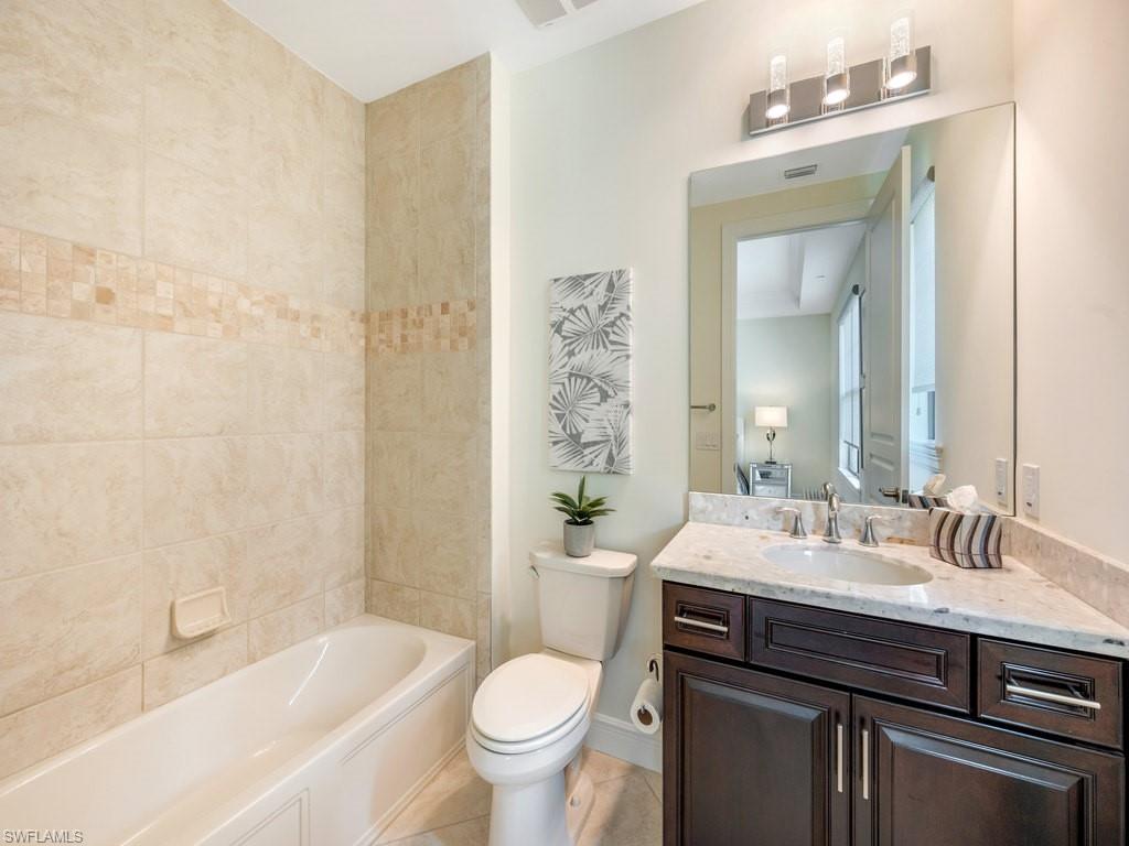 16425 Carrara Way, Unit 101 Naples, FL 34110 - Photo 19 of 21 a bathroom with a sink a toilet and shower