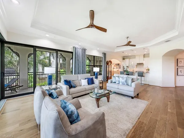 a living room with furniture and large windows