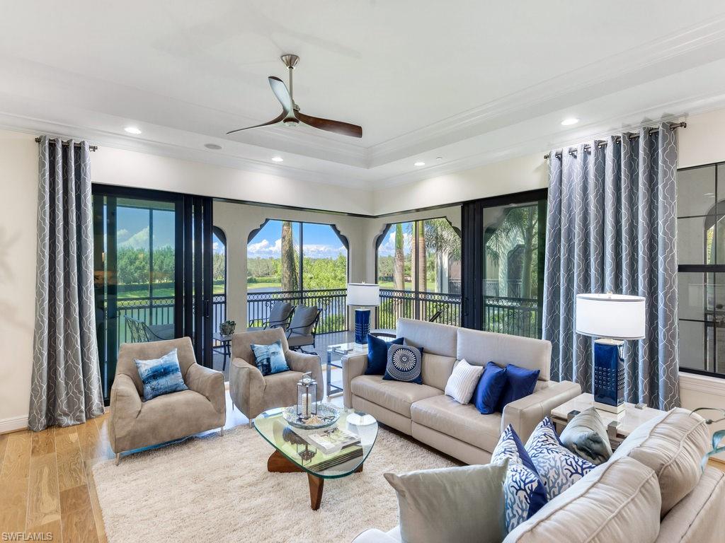 16425 Carrara Way, Unit 101 Naples, FL 34110 - Photo 3 of 21 a living room with furniture fireplace and a large window