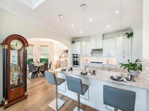a kitchen with a table chairs stove and cabinets