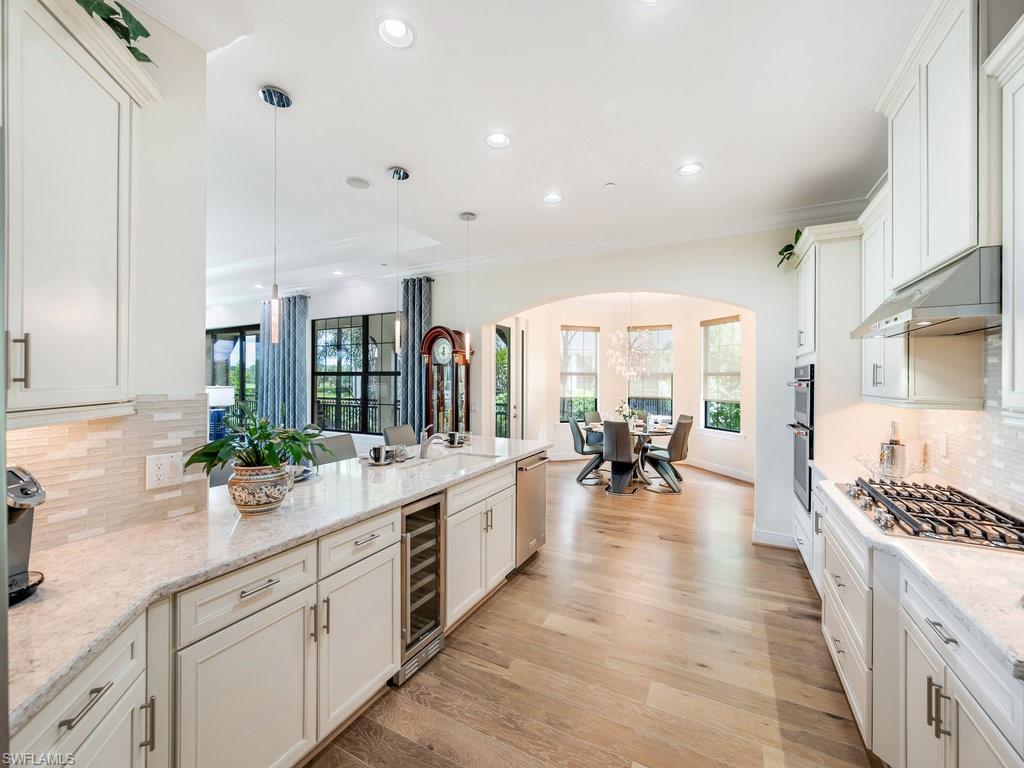 16425 Carrara Way, Unit 101 Naples, FL 34110 - Photo 5 of 21 a kitchen with sink and view of living room
