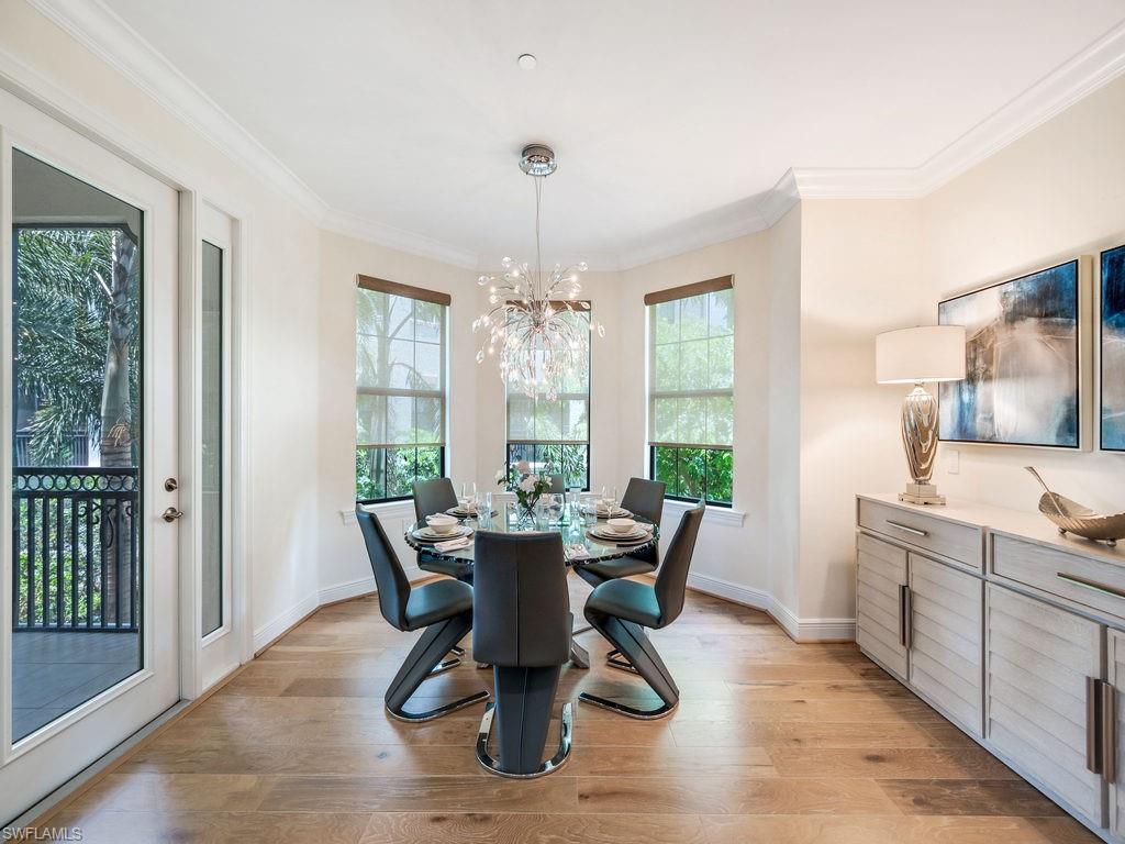 16425 Carrara Way, Unit 101 Naples, FL 34110 - Photo 6 of 21 a view of a dining room with furniture window and outside view