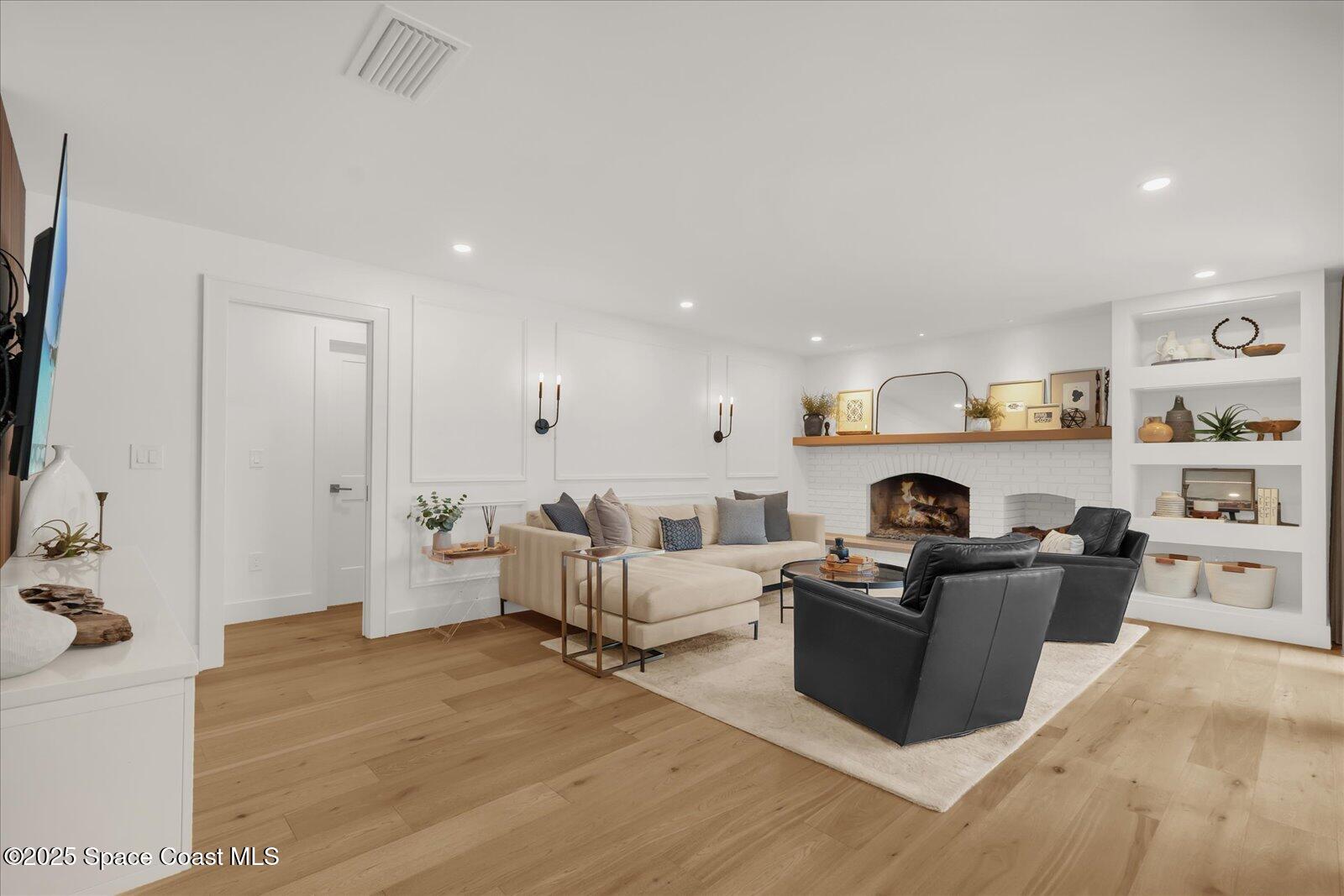 3204 Nottingham Lane Cocoa, FL 32926 - Photo 15 of 36 a living room with furniture and a fireplace