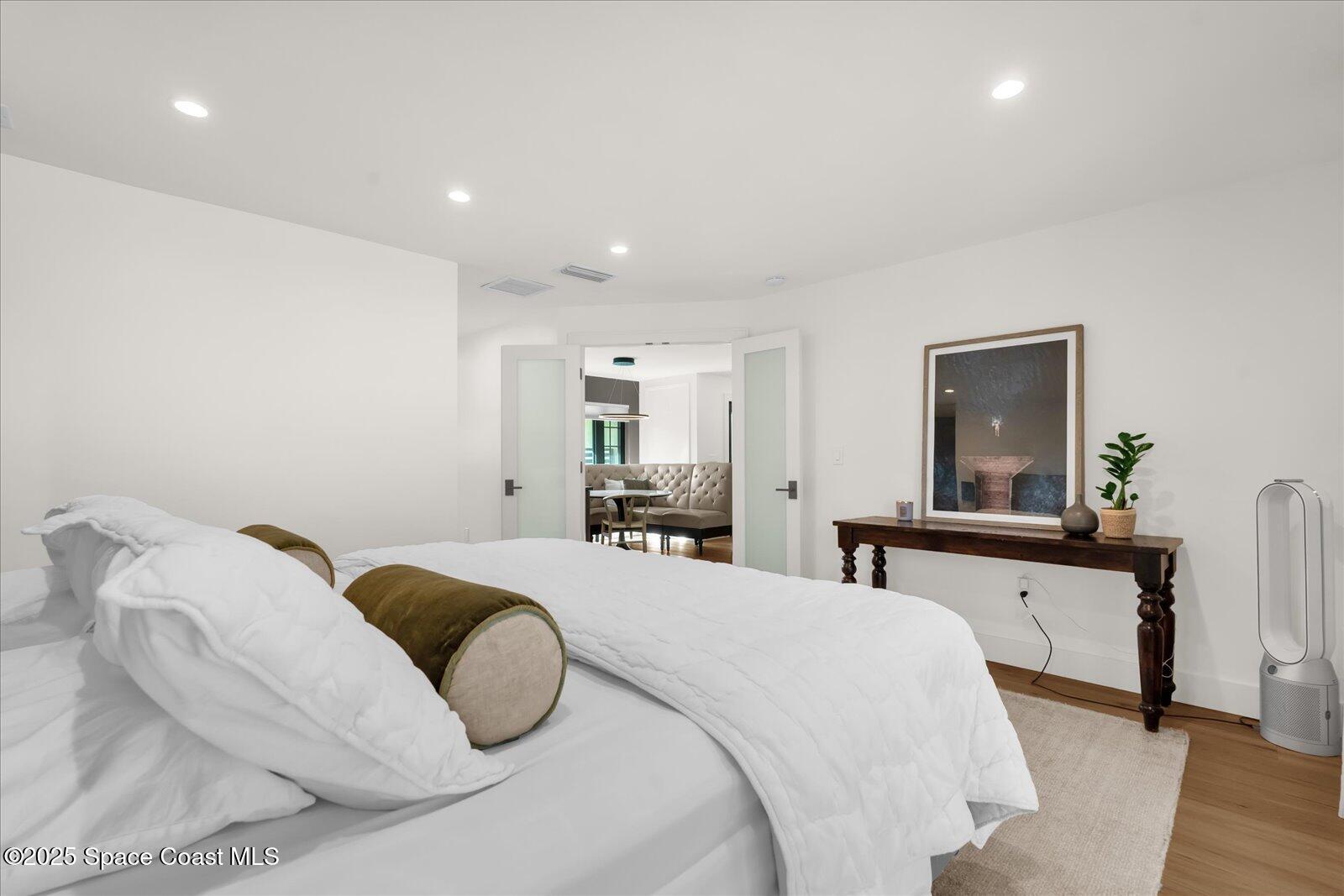 3204 Nottingham Lane Cocoa, FL 32926 - Photo 16 of 36 a bedroom with a bed and a large mirror