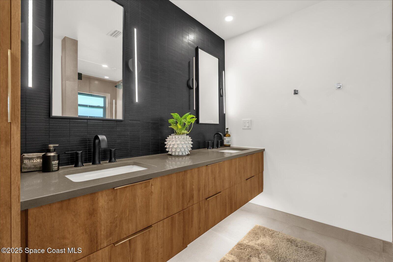 3204 Nottingham Lane Cocoa, FL 32926 - Photo 18 of 36 a bathroom with a double vanity sink and a mirror