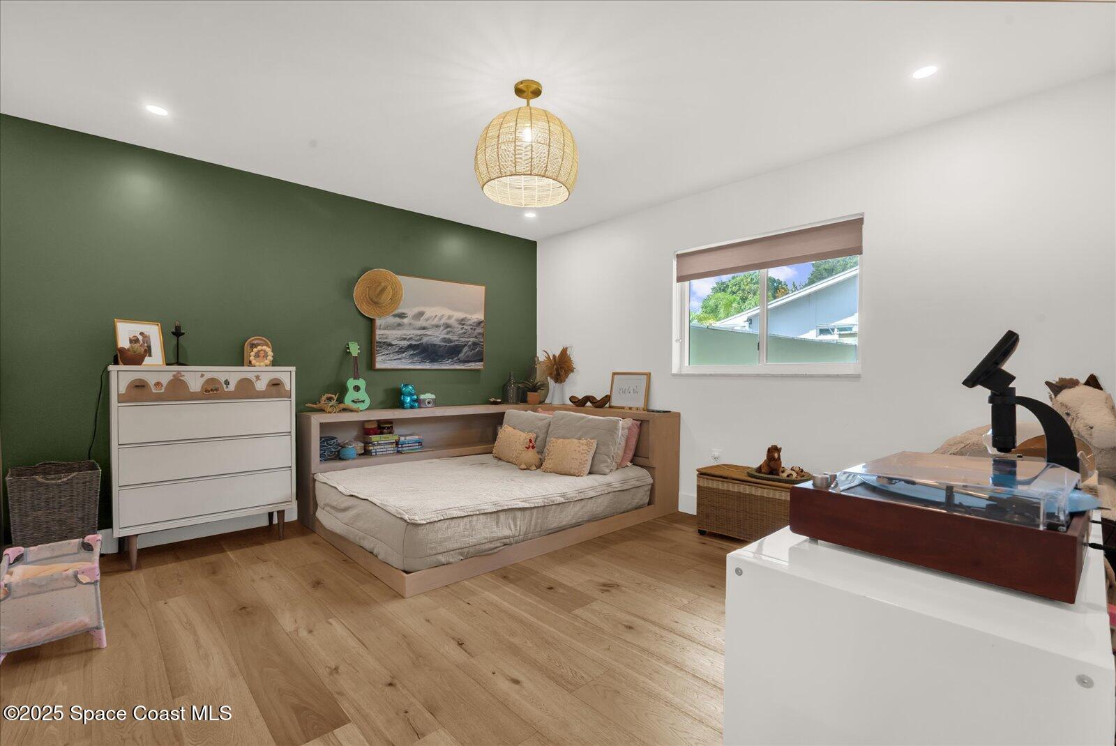 3204 Nottingham Lane Cocoa, FL 32926 - Photo 25 of 36 a bedroom with a bed and a chandelier