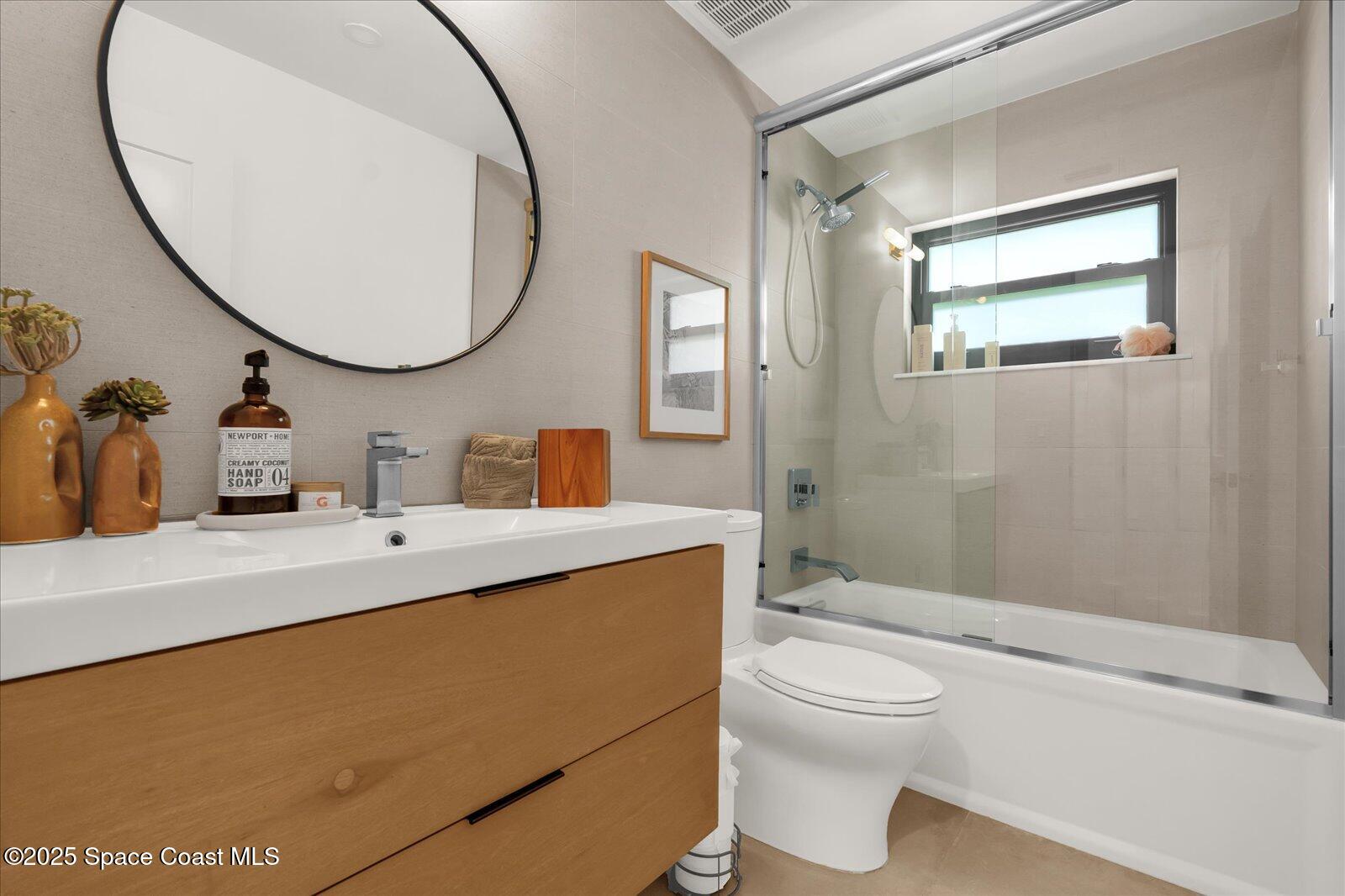 3204 Nottingham Lane Cocoa, FL 32926 - Photo 26 of 36 a bathroom with a toilet a sink and a mirror