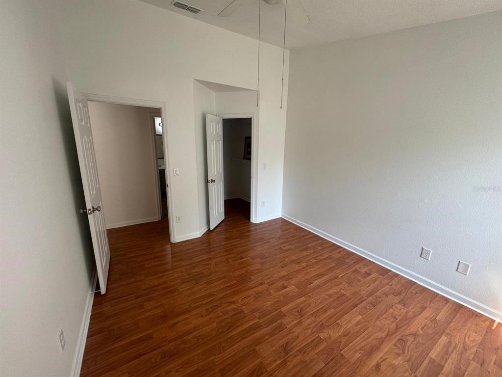 4320 South Kirkman Road, Unit 1508 Orlando, FL 32811 - Photo 14 of 25 an empty room with wooden floor and entrance