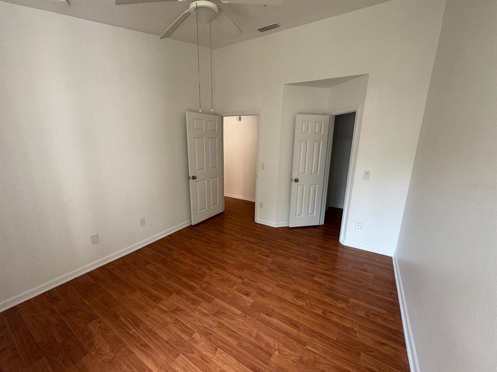 4320 South Kirkman Road, Unit 1508 Orlando, FL 32811 - Photo 15 of 25 a view of an empty room with wooden floor