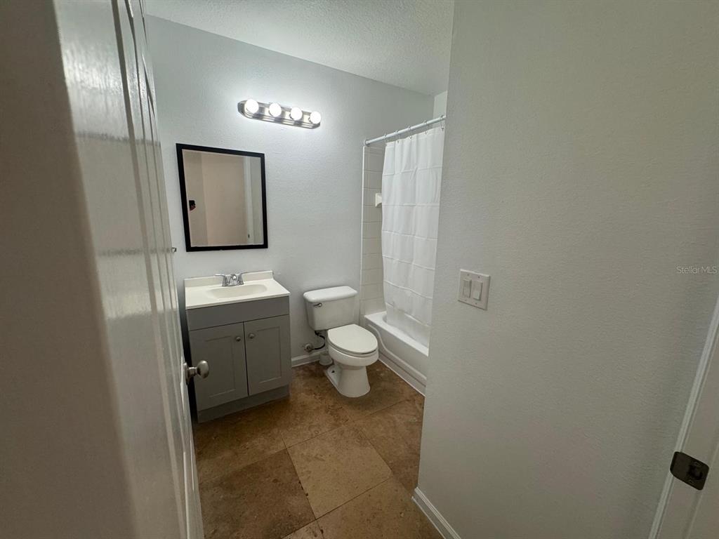 4320 South Kirkman Road, Unit 1508 Orlando, FL 32811 - Photo 16 of 25 a bathroom with a toilet sink and mirror