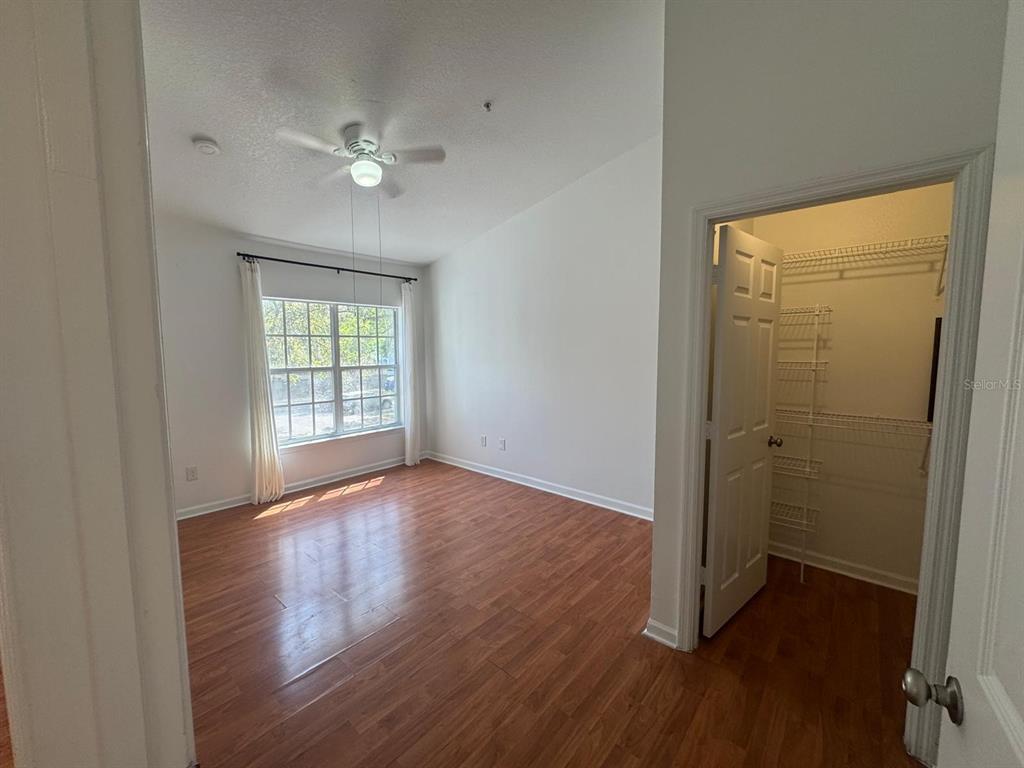 4320 South Kirkman Road, Unit 1508 Orlando, FL 32811 - Photo 17 of 25 wooden floor in an empty room with a window