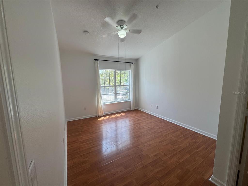 4320 South Kirkman Road, Unit 1508 Orlando, FL 32811 - Photo 18 of 25 an empty room with wooden floor and windows