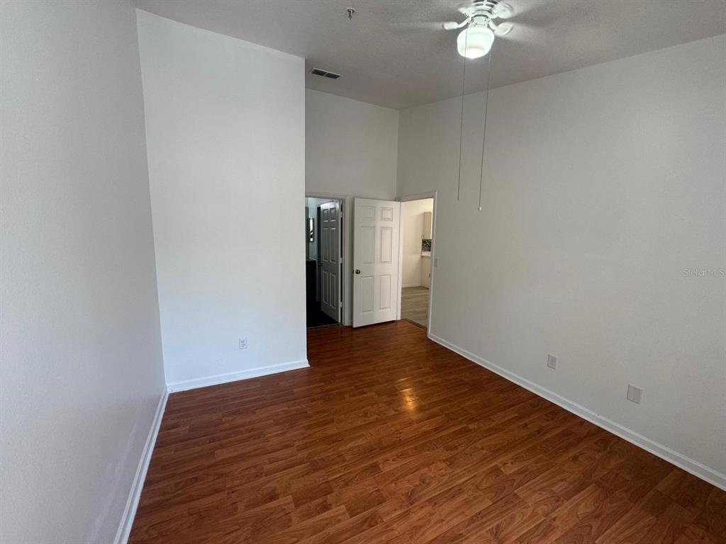 4320 South Kirkman Road, Unit 1508 Orlando, FL 32811 - Photo 19 of 25 a view of an empty room with wooden floor