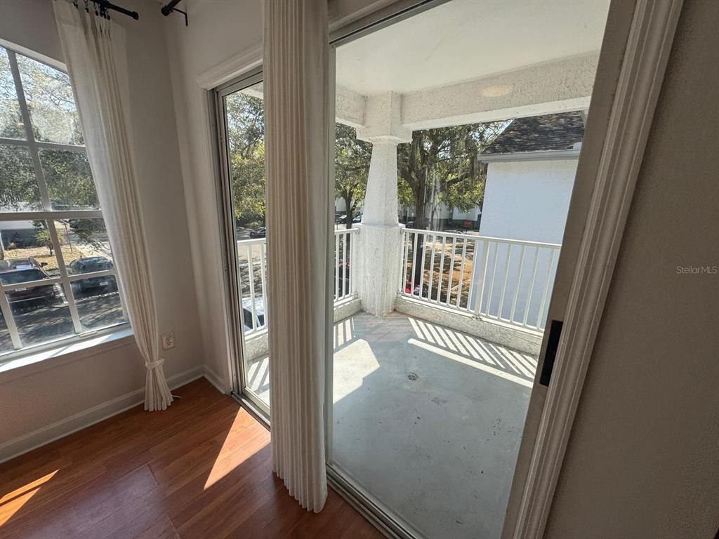 4320 South Kirkman Road, Unit 1508 Orlando, FL 32811 - Photo 8 of 25 a view of a hallway with wooden floor and windows