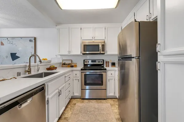 a kitchen with a refrigerator sink and microwave