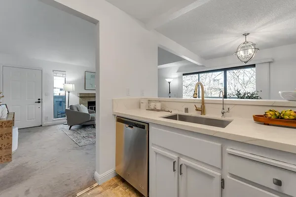 a kitchen with sink refrigerator and window