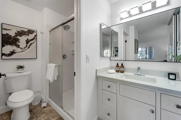 a bathroom with a toilet sink and mirror