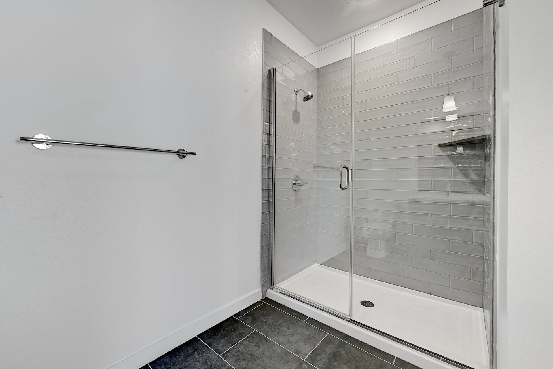4801 Springdale Road, Unit 1301 Austin, TX 78723 - Photo 23 of 39 A sleek, contemporary walk-in shower features cool gray subway tile and a spacious glass enclosure.