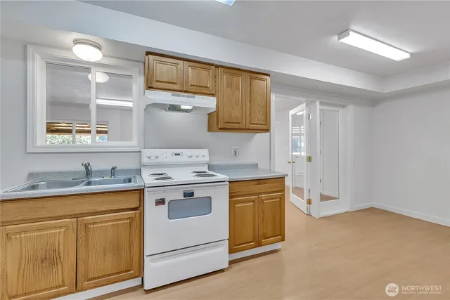 a kitchen with a sink stove and cabinets