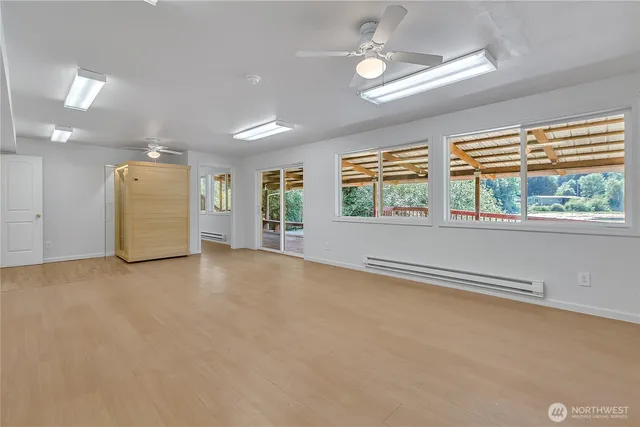 an empty room with windows and mountain view