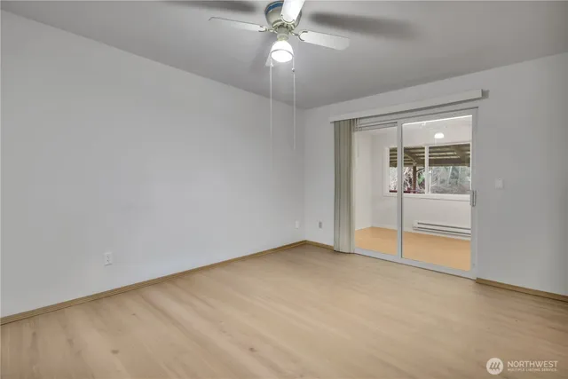 an empty room with a empty space and a ceiling fan