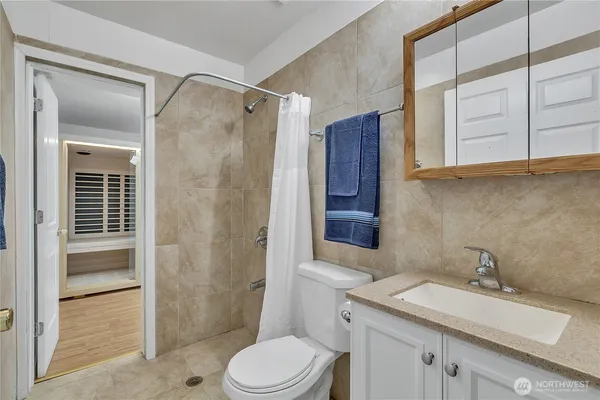 a bathroom with a sink toilet and shower