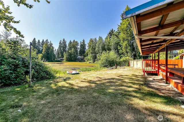 a view of a backyard with swimming pool