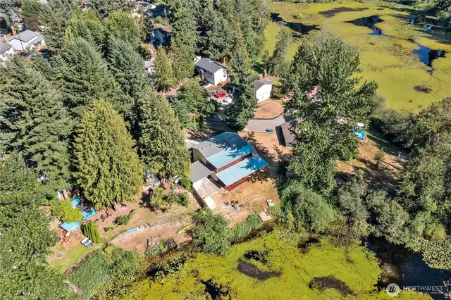 an aerial view of a houses with swimming pool