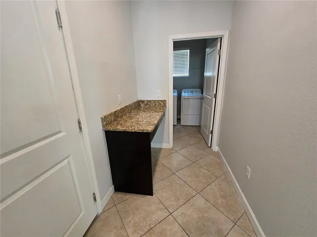 a bathroom with a granite countertop sink and vanity