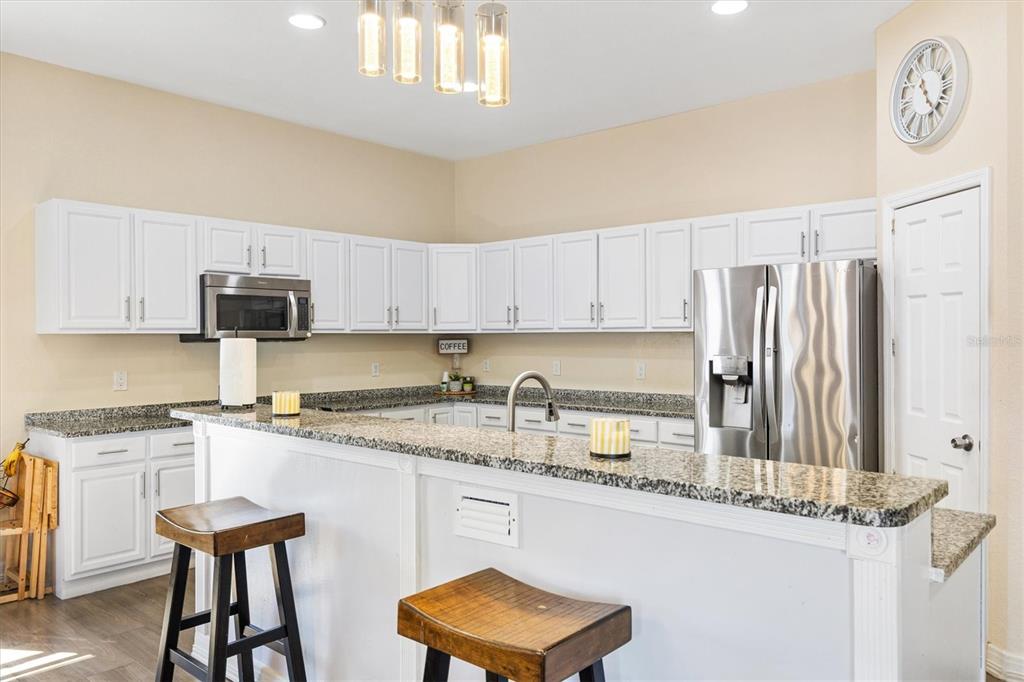 227 Locust Pass Course Ocala, FL 34472 - Photo 14 of 41 a kitchen with stainless steel appliances granite countertop a sink stove and refrigerator