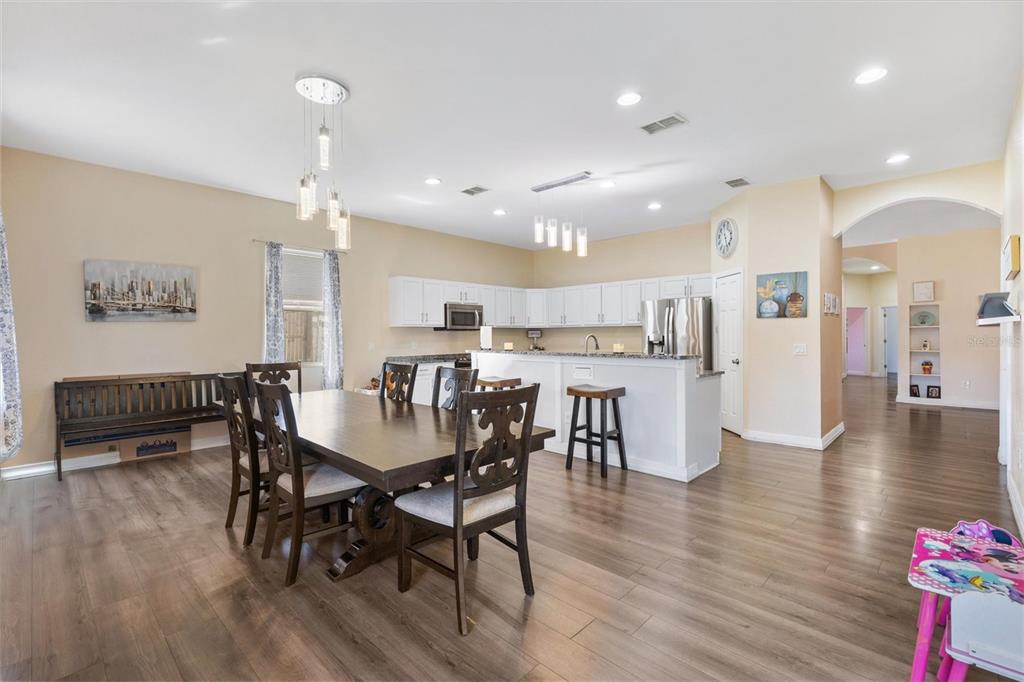 227 Locust Pass Course Ocala, FL 34472 - Photo 17 of 41 a view of a dining area with furniture and wooden floor