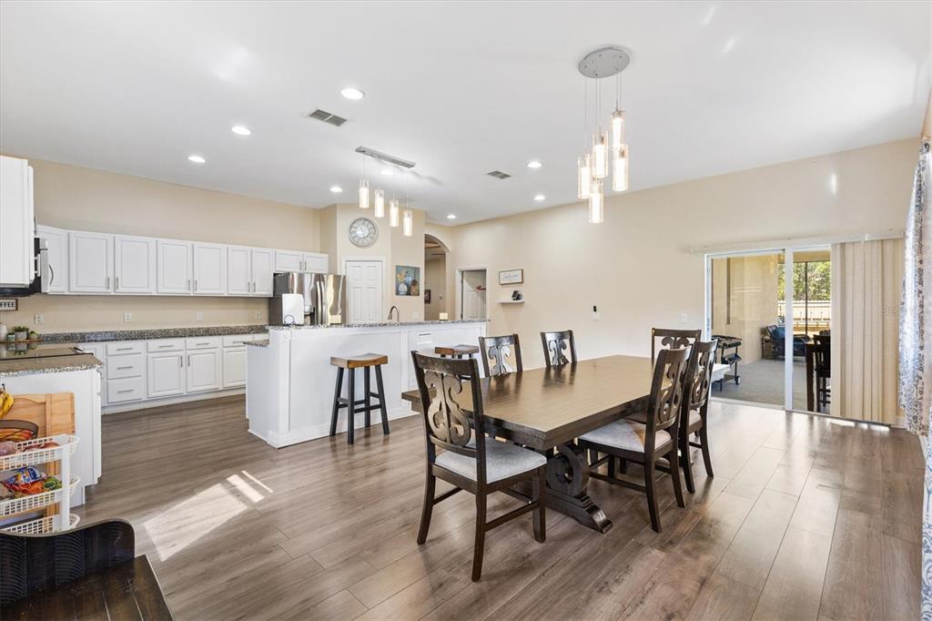 227 Locust Pass Course Ocala, FL 34472 - Photo 18 of 41 a view of a dining area with furniture and wooden floor