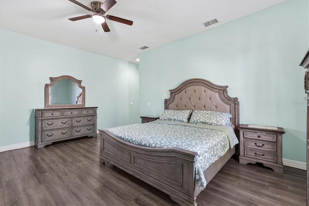 227 Locust Pass Course Ocala, FL 34472 - Photo 20 of 41 a bedroom with a bed and a dresser