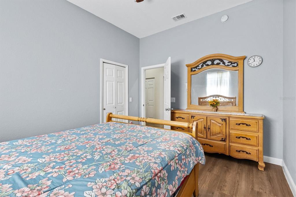 227 Locust Pass Course Ocala, FL 34472 - Photo 23 of 41 a bedroom with a bed and a dresser