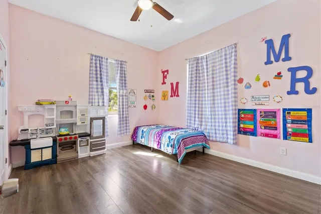 a bedroom with furniture and a book shelf