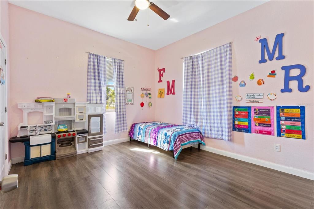 227 Locust Pass Course Ocala, FL 34472 - Photo 24 of 41 a bedroom with furniture and a wooden floor