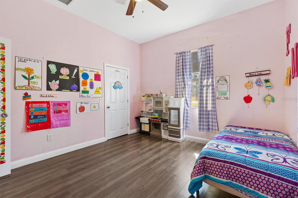 227 Locust Pass Course Ocala, FL 34472 - Photo 25 of 41 a bedroom with furniture and a book shelf