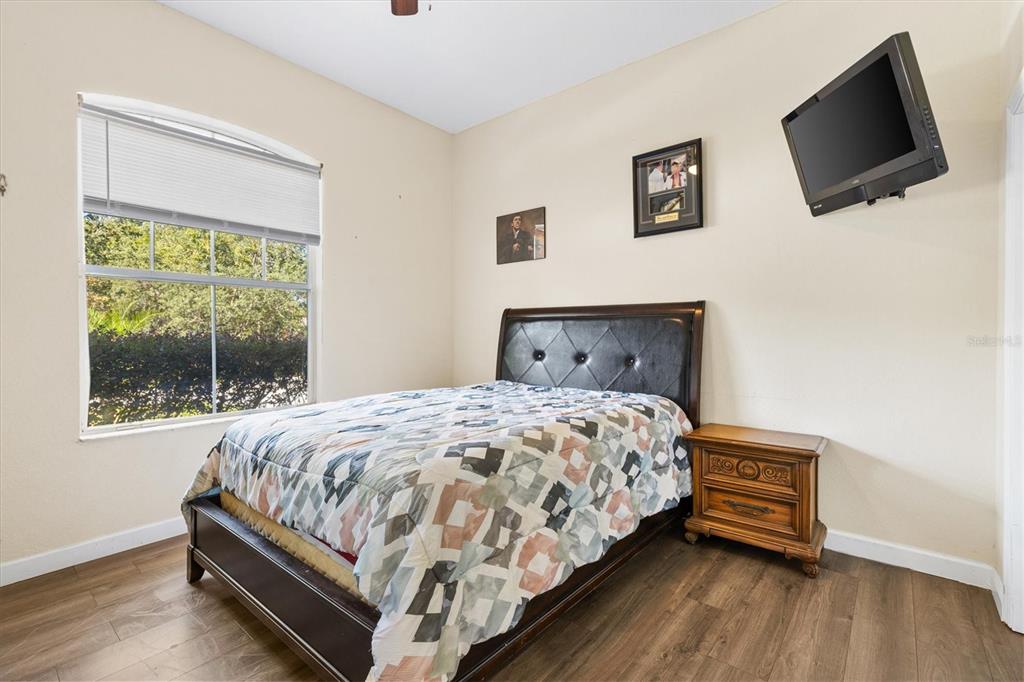 227 Locust Pass Course Ocala, FL 34472 - Photo 27 of 41 a bed sitting in a bedroom next to a window