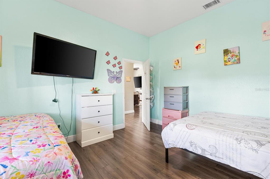 227 Locust Pass Course Ocala, FL 34472 - Photo 30 of 41 a bedroom with a bed and a flat screen tv